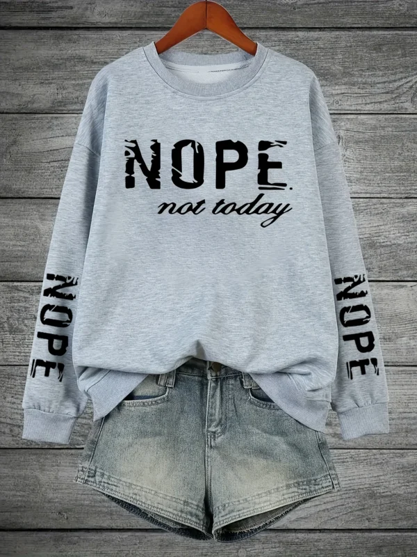 Woman wearing a "Nope Not Today" retro print sweatshirt.