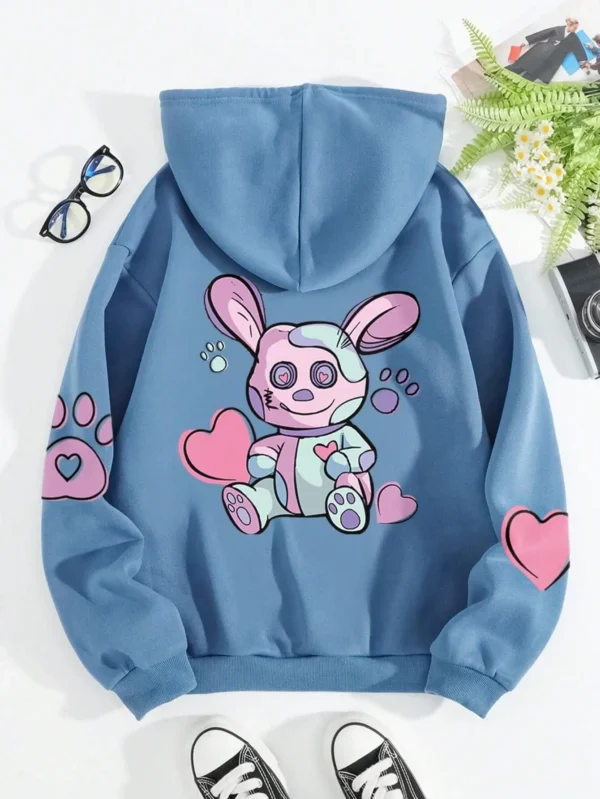 Woman wearing an oversized hoodie with a cute rabbit graphic print