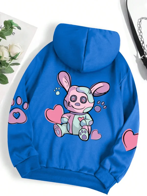 Woman wearing an oversized hoodie with a cute rabbit graphic print
