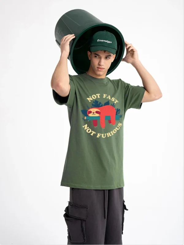 Model wearing funny 'Not Fast Not Furious' sloth graphic tee in breathable cotton. Unisex casual summer style.