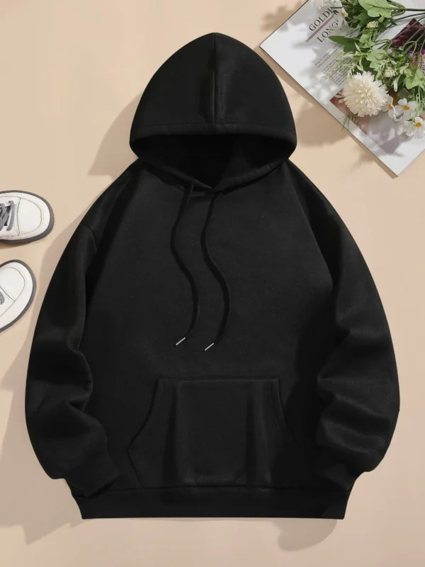 Woman wearing oversized fleece hoodie with large bear cartoon print - Harajuku streetwear style.