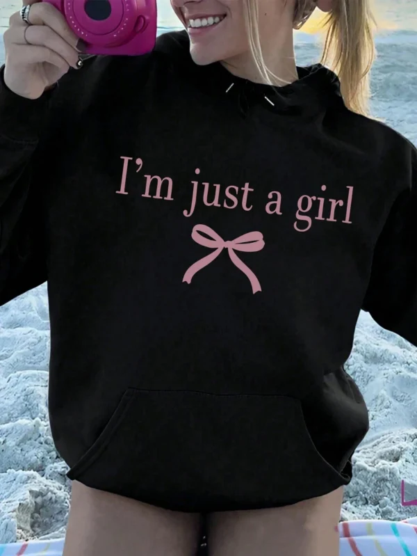 Woman wearing the warm fleece-lined 'I'm Just A Girl' pullover hoodie against a neutral background.