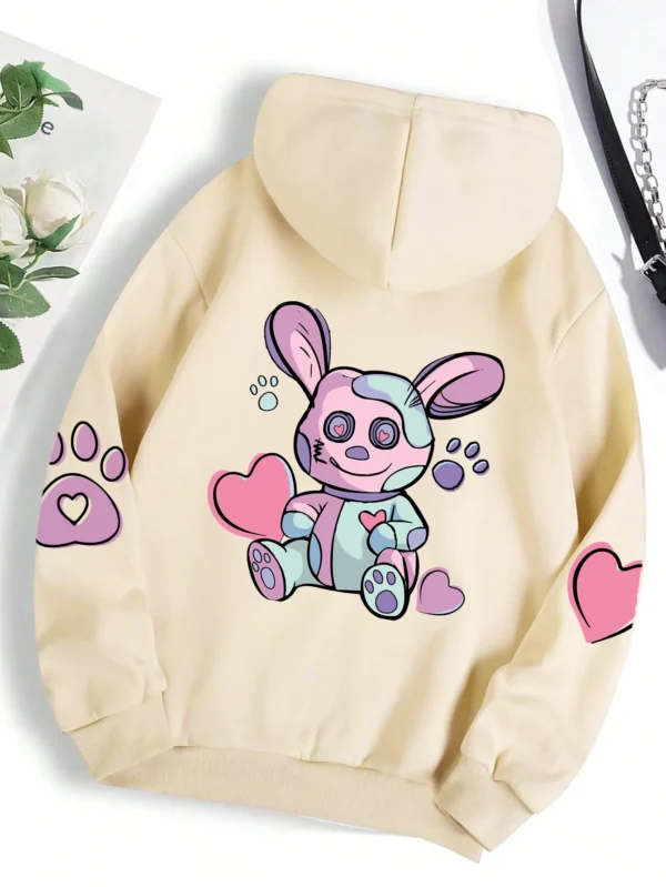 Woman wearing an oversized hoodie with a cute rabbit graphic print