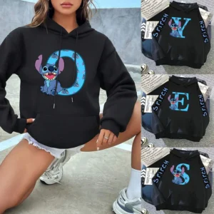 Woman wearing a black pullover hoodie with a colorful Disney Lilo & Stitch graphic print on the front.