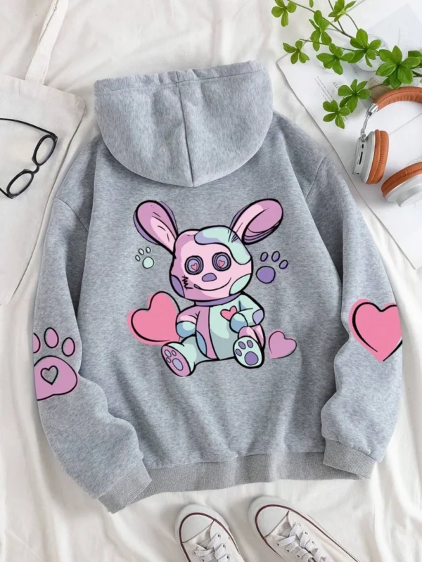 Woman wearing an oversized hoodie with a cute rabbit graphic print
