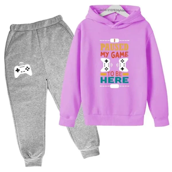 Kids gamer tracksuit set with 'I Paused My Game To Be Here' slogan on hooded sweatshirt and matching pants for boys or girls.