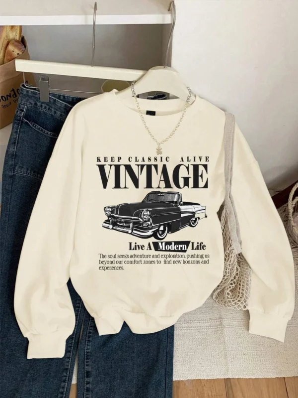 Woman wearing an oversized grey hoodie sweatshirt with a vintage car print