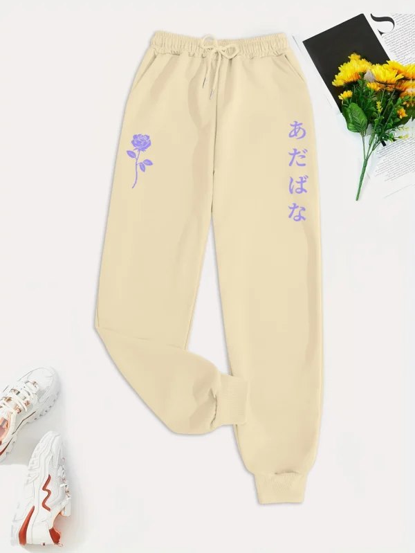 Women's purple hip hop sweatpants with white floral and letter graphic print