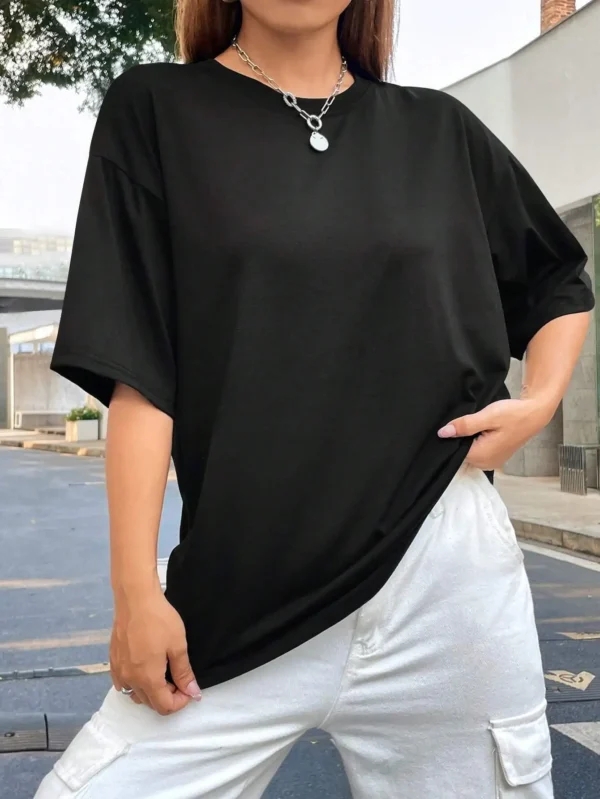 Woman wearing comfortable O-neck "Jesus Loves You" Christian graphic t-shirt for summer against a plain background.
