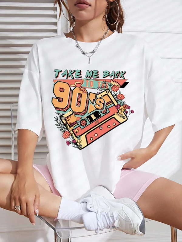 Woman wearing a soft white t-shirt with a colorful retro 'Take Me Back 90s' graphic print.