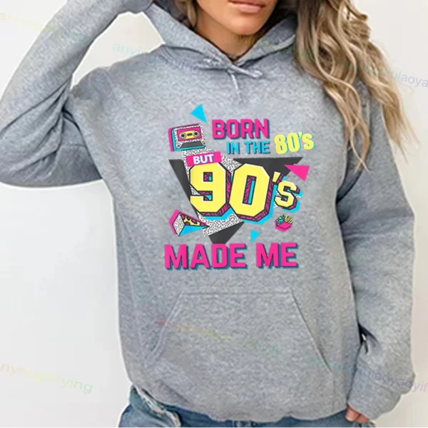 Woman wearing a vibrant neon hoodie with 'Take Me Back To The 90's' graphic print