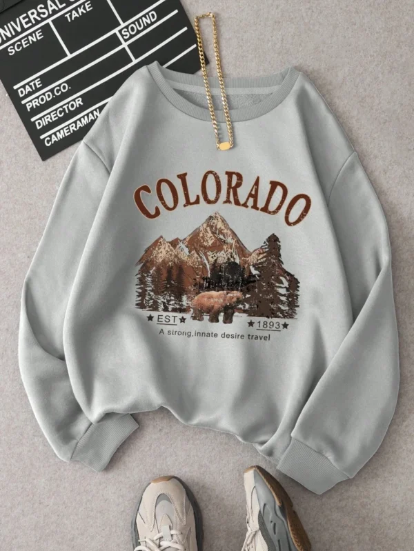 Woman wearing vintage travel print oversized hoodie