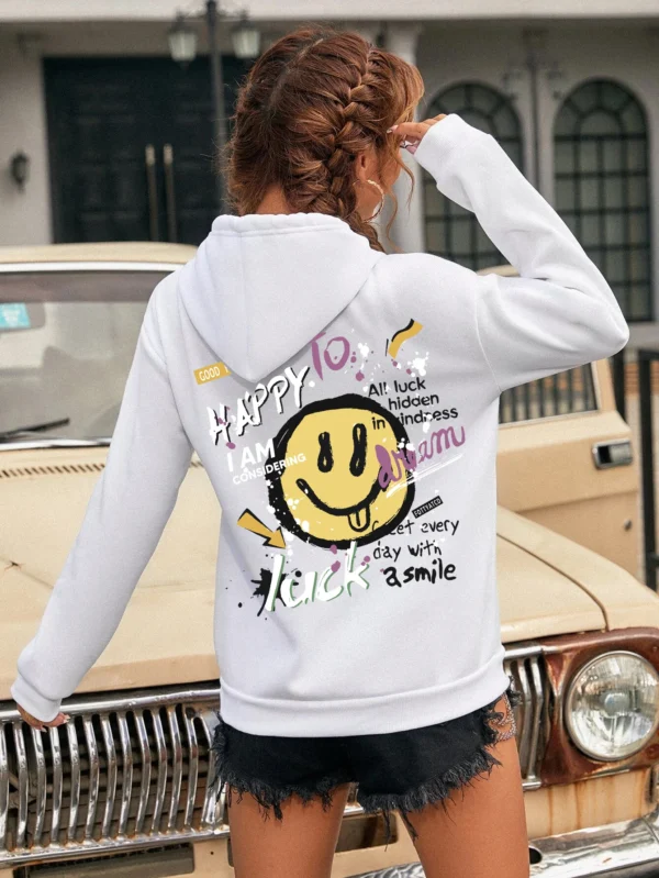 Woman wearing a casual fleece-lined hoodie with a colourful all-over graffiti street art print.