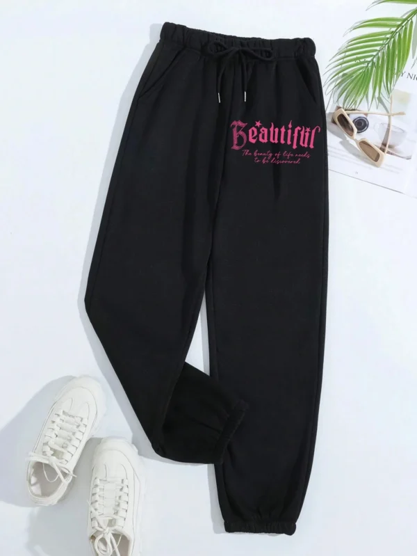 Women's pink loose casual hip hop pants with white letter print graphic - streetwear style trousers for autumn/winter.