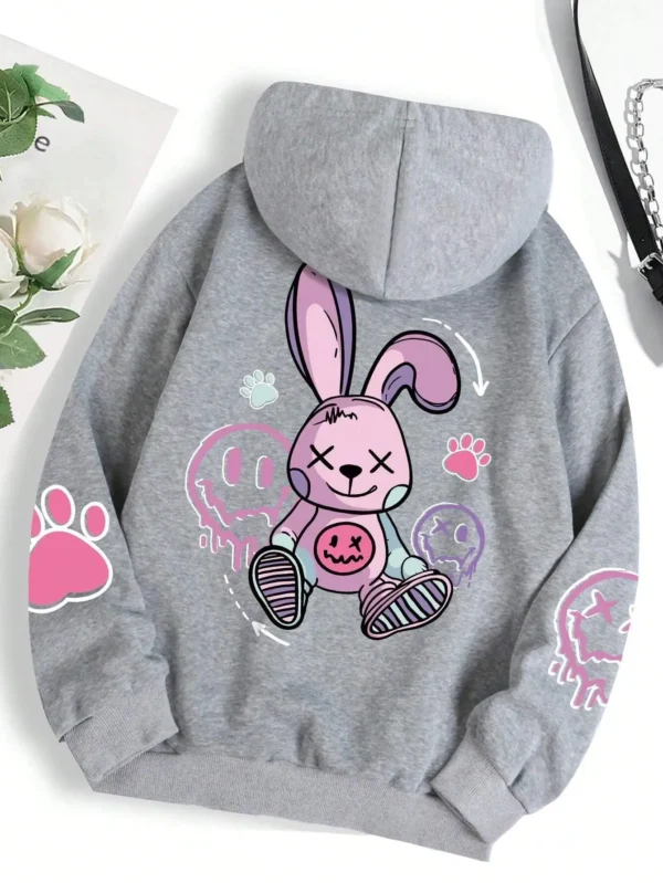 Woman wearing oversized black printed streetwear hoodie with artificial fur lining