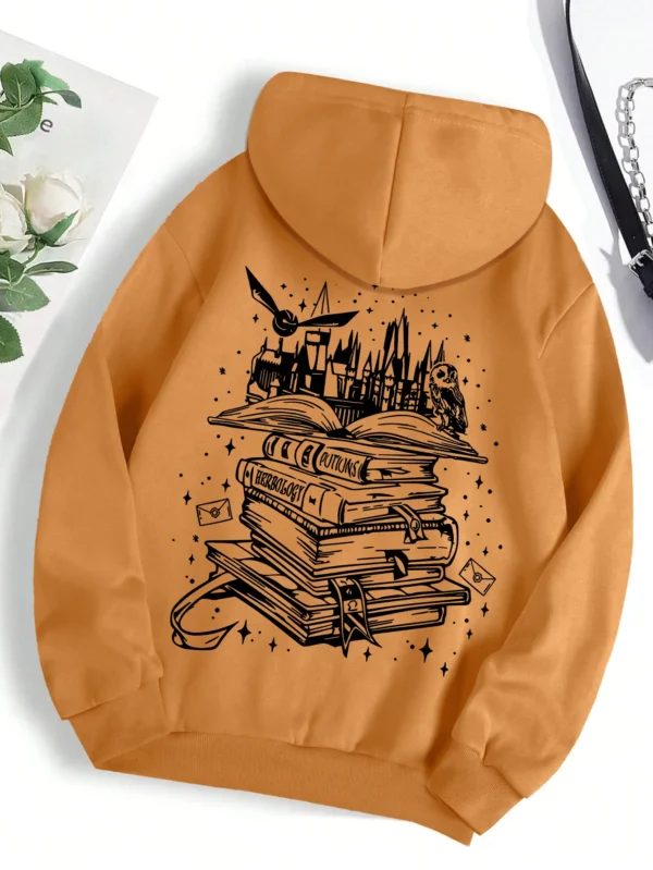 Woman wearing a cozy grey pullover hoodie with a humorous book-themed print on the front