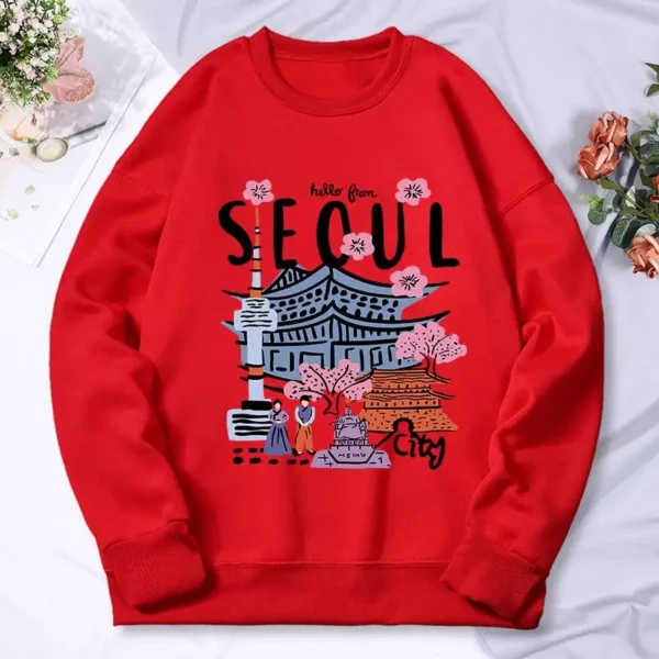 Woman wearing a warm casual hoodie with a colorful Seoul cityscape scenery print.
